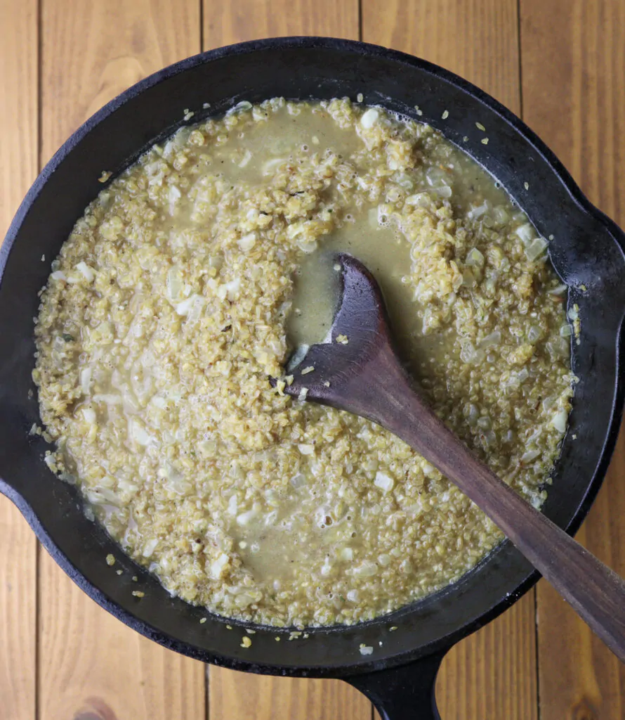 Adding hot vegetable stock to the pan.