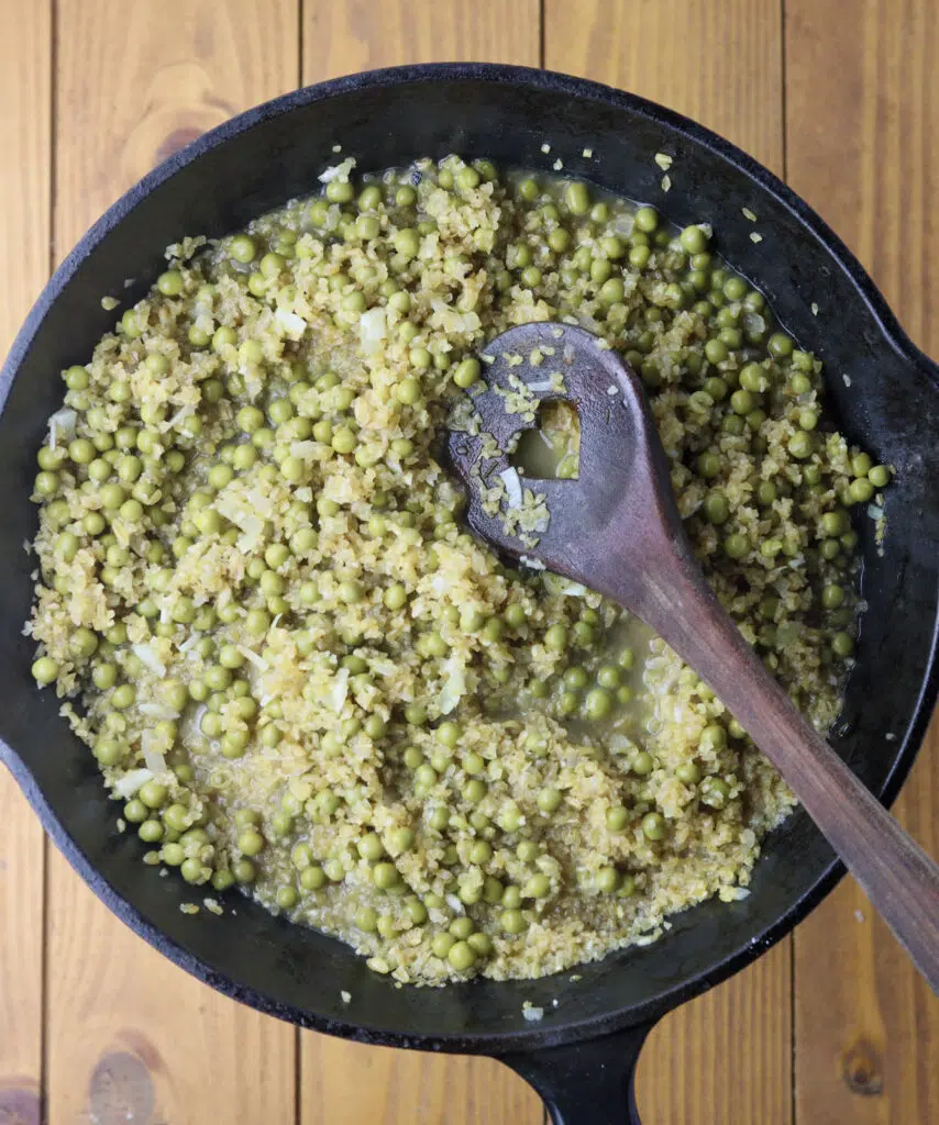 Image showing bulgur risotto cooking in a pan with sweet peas added. 