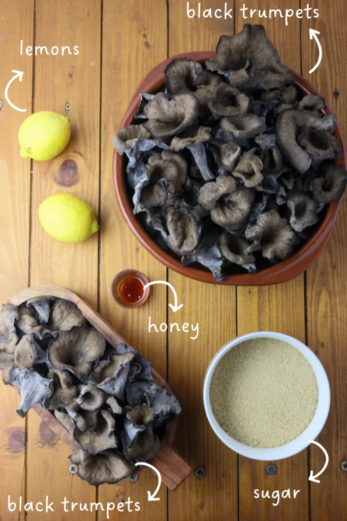 gathering ingredients for mushroom jar: black trumpet mushrooms, brown sugar, forest honey and lemons