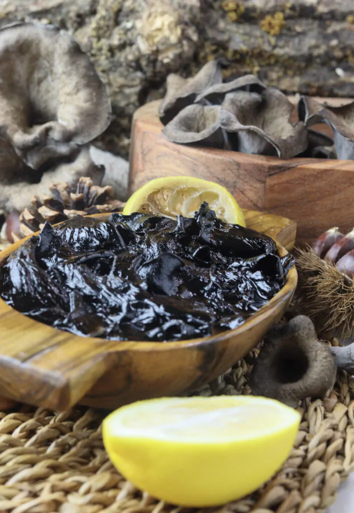 mushroom jam with black trumpet mushrooms in the background